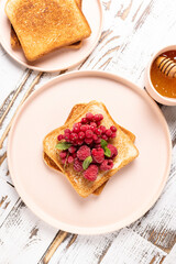 Toast with frozen raspberries and red currants