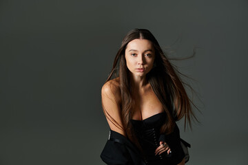 Naklejka premium Beautiful young gymnast demonstrates impressive agility and style in a modern, artistic setup
