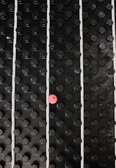 Underfloor heating system installation showing modular black panels and white pipes