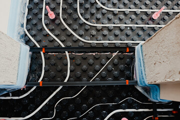 Installing underfloor heating system with insulation and pipes