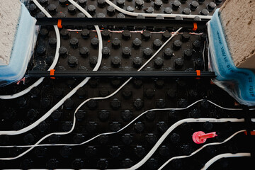Installing underfloor heating system pipes and insulation material
