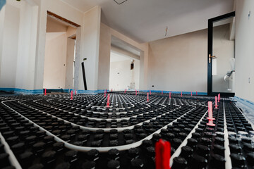 Installing underfloor heating system in new home construction project