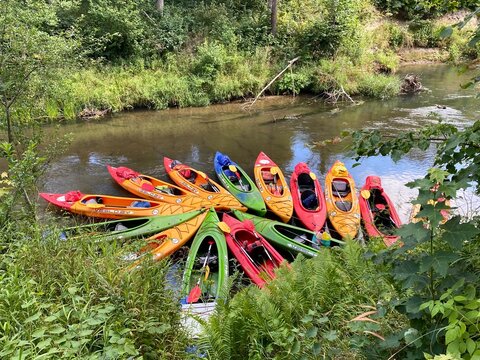 08/02/2020 Isloch river,  Belarus. Colorful Kayaks Arranged in a Circle on a River
