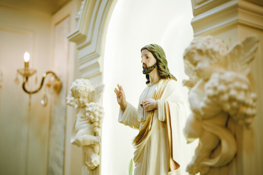 side view of Jesus in white robe in between bright architectural structure