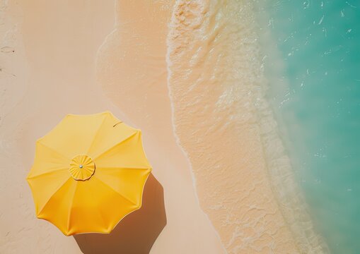 Sunny yellow umbrella on a tranquil beach setting.