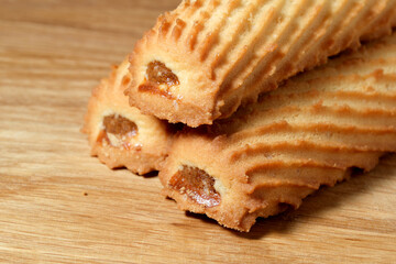 Delicious baked treats with sweet filling resting on a wooden surface