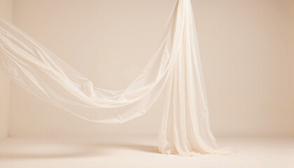 Elegantly draped sheer fabric against pale background, minimalist beauty