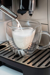 Modern coffee machine with glass bowl, makes coffee, cappuccino, espresso and latte