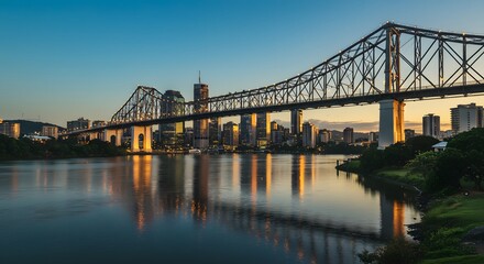 Obraz premium Brisbane Story Bridge and City Skyline at Sunset Reflecting in Calm River
