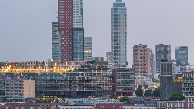 Panoramic aerial night to day transition timelapse of Katendrecht peninsula and Maashaven harbour in Rotterdam, The Netherlands. City skyline modern skyscrapers and traditional Dutch waterfront houses
