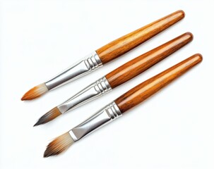 Fototapeta premium Three Paintbrushes with Wooden Handles and Silver Ferrules on White Background for Art Supplies and Creative Projects