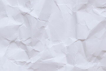 Fototapeta premium Crumpled white paper background. Crumpled white paper texture or paper background. Light background with copy space. Top view