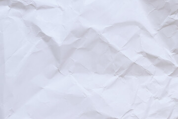 Fototapeta premium Crumpled white paper background. Crumpled white paper texture or paper background. Light background with copy space. Top view