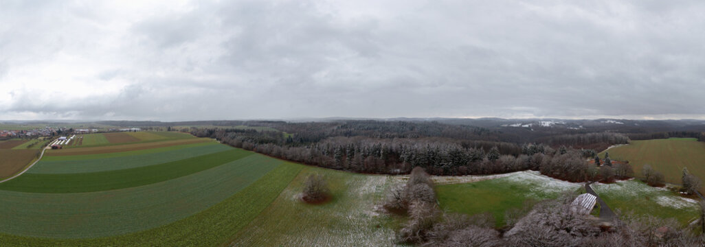 Winter landscape in Germany with frozen frost on trees and fields, drone shot