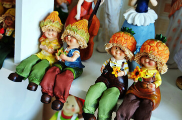 Souvenir toys and vintage resin children boy doll and retro kid girl figurine and friends figure on shelf for show in local gift shop for thai people visit and select buy in Bangkok, Thailand