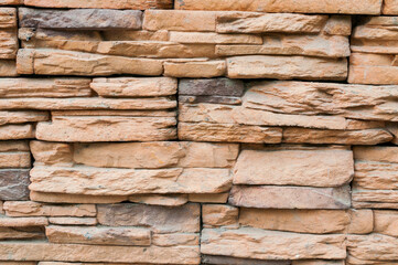 Stone wall texture, wall made of natural sandstone bricks, texture background of stone bricks made of sand