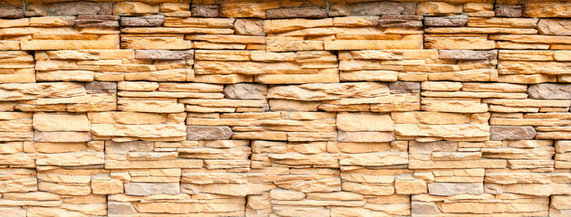 Texture background of stone bricks made of sand, stone background of stone wall made of sand stone blocks, vintage filter applied