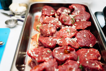 raw filet mignon sprinkled with garlic and seasonings