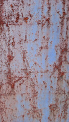 Weathered Steel: Textured close-up of aged and distressed steel panel, showcasing rich rust formations on a blue surface, evoking a sense of industrial history and resilience.