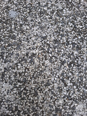 Stone Texture: A close-up view captures the intricate texture of an outdoor stone surface, revealing the unique patterns, variations and colors of the material. 