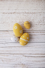 yellow easter eggs on rustic wooden background