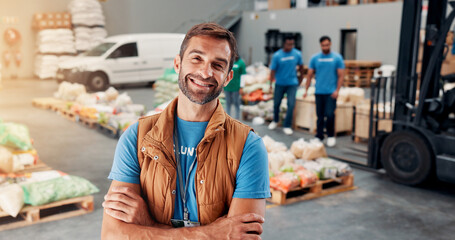 Obraz premium Portrait, volunteer and man with arms crossed, food distribution center and confidence. Face, people and charity workers with NGO project, kindness and social responsibility with community fundraiser