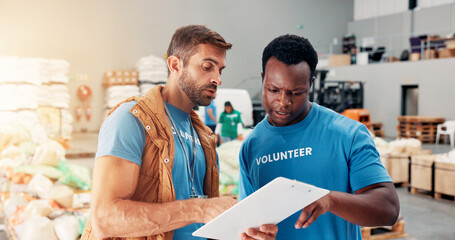 Obraz premium Men, volunteer and talk with clipboard at warehouse for donation stock, inventory checklist and charity. People, team and grocery notes for humanitarian aid, ngo welfare and food list of distribution