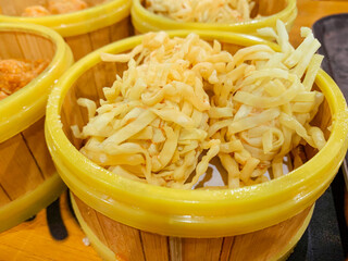 Fried Dumplings covered with fried noodle in a bamboo steamer bowl. Chinese food menu.