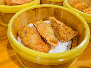 Fried Dumplings in a bamboo steamer bowl. Chinese food menu.