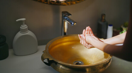 Close up of female use soap do hand wash in sink tap water for hygiene germ virus and safety indoor...