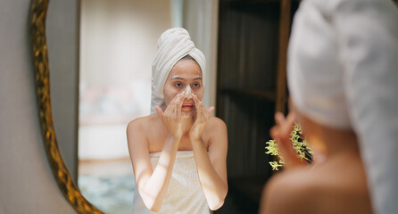 Indian young adult gen z woman lady teen girl female wrapped towel on head and body look mirror use...