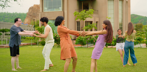 Indian happy family group play game running with cute son kid boy enjoy day outdoor home park Adult mom dad man woman young male female teen girl child have fun joy spend time at outside garden house