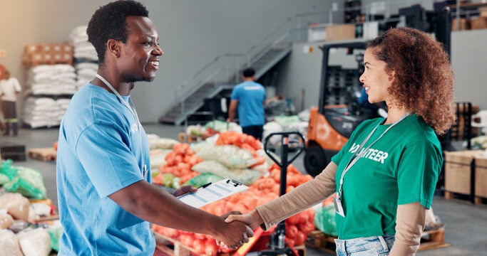 Shaking hands, welcome and volunteers for donation at food drive, charity or non profit organization. Activism, client and NGO worker with vendor for partnership handshake in community center.