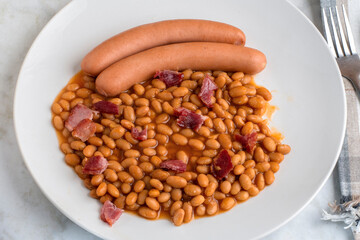 two hot dogs  served with bked beans  and bcaon bits