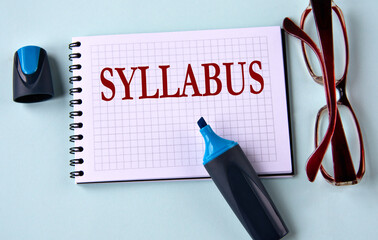 SYLLABUS - word on a white sheet with glasses and marker in the background