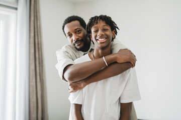 Father and teen son having great time on the livingroom