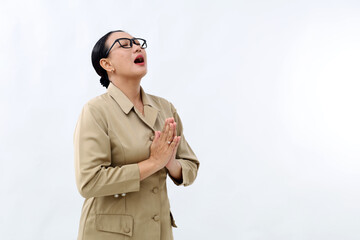 Indonesian civil servant woman praying and begging for something