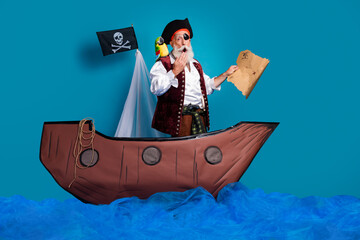 Photo of shocked pirate in costume swimming in sea holding map isolated on blue color background