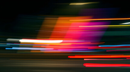 Vibrant streaks of light illustrating speed and motion on a nighttime highway.