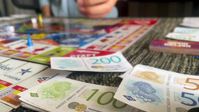 Playing a Board Game with Play Money, Strategy and Fun for the Whole Family