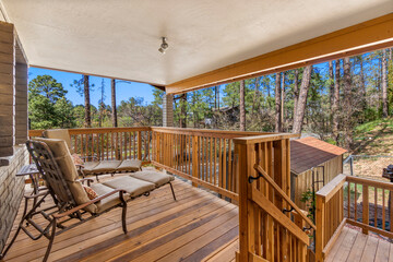A beautifully crafted wooden deck with chairs and a staircase