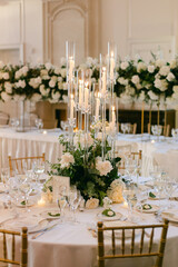 Elegant dining table setup featuring floral arrangements and candlelight for a special event at an upscale venue