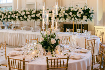 Elegant wedding reception table arrangement with floral centerpieces and fine dining setup in bright venue