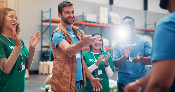 Smile, people and volunteer for applause of teamwork, introduction or good news for donation winner. Staff, clapping and celebration at charity event, aid promotion and achievement in welfare funding