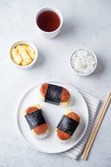 Sausage omelette sushi Musubi in a plate on a white background