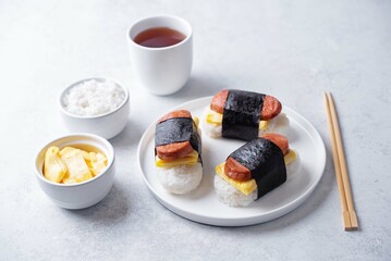 Sausage omelette sushi Musubi in a plate on a white background