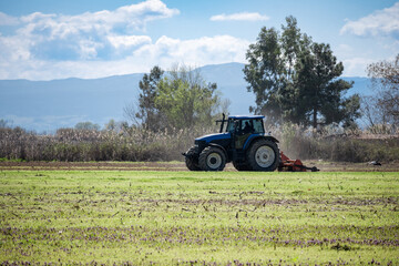 side view of tractor preparing the fields for cultivation
