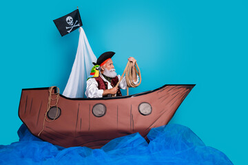 Photo of brave confident sailor man traveling wooden boat empty space isolated on blue color background