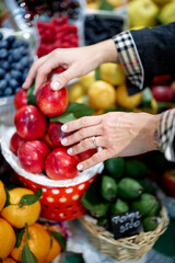 woman holding a basket of vegetables