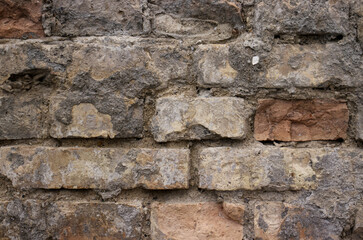 Old brick wall with fallen plaster. Brick wall with broken bricks. Brick wall texture. Building, brick pattern.